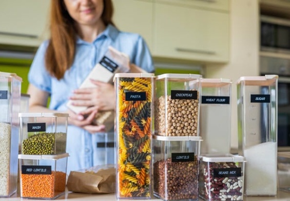 closeup-housewife-posing-with-marking-sticker-names-titles-bulk-products-plastic-case-box.jpg