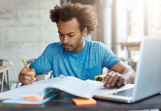 concentrated-afro-american-hipster-male-blue-t-shirt-preparing-examination-test.jpg