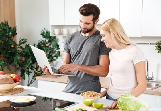 happy-young-loving-couple-standing-kitchen-cooking.jpg