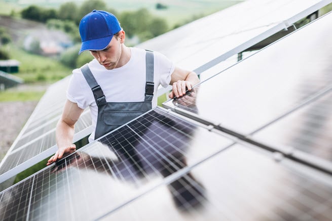 man-worker-firld-by-solar-panels.jpg