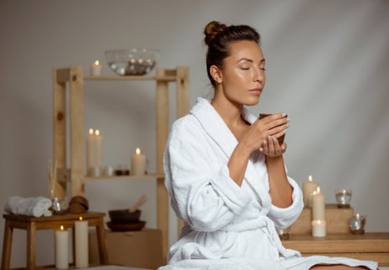 young-woman-holding-tea-cup-relaxing-spa-salon.jpg