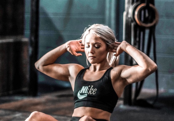 woman in black tank top and black shorts sitting on floor